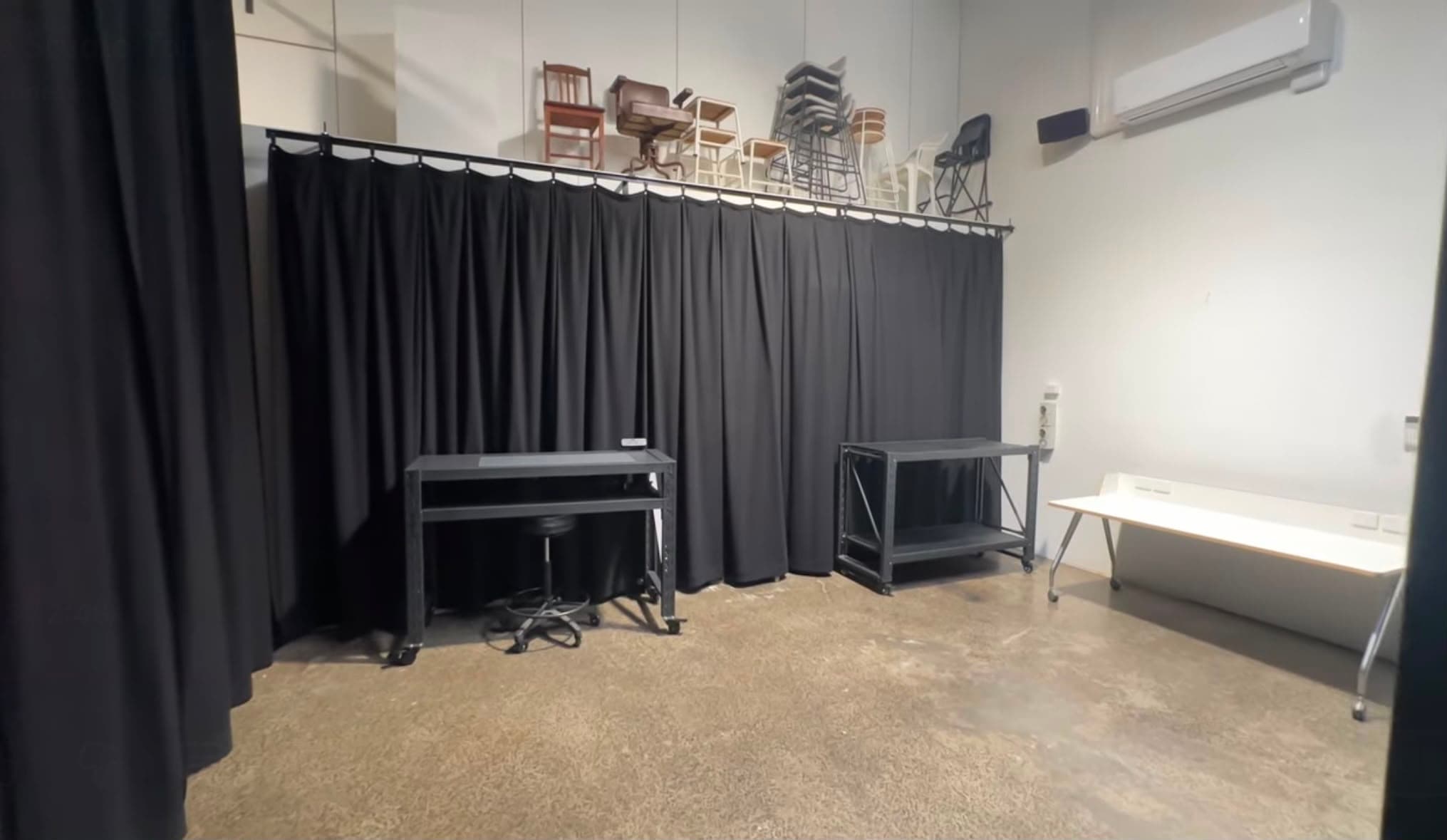 Studio B at Crate Studio — a black curtain backdrop with a digi station and rolling rack